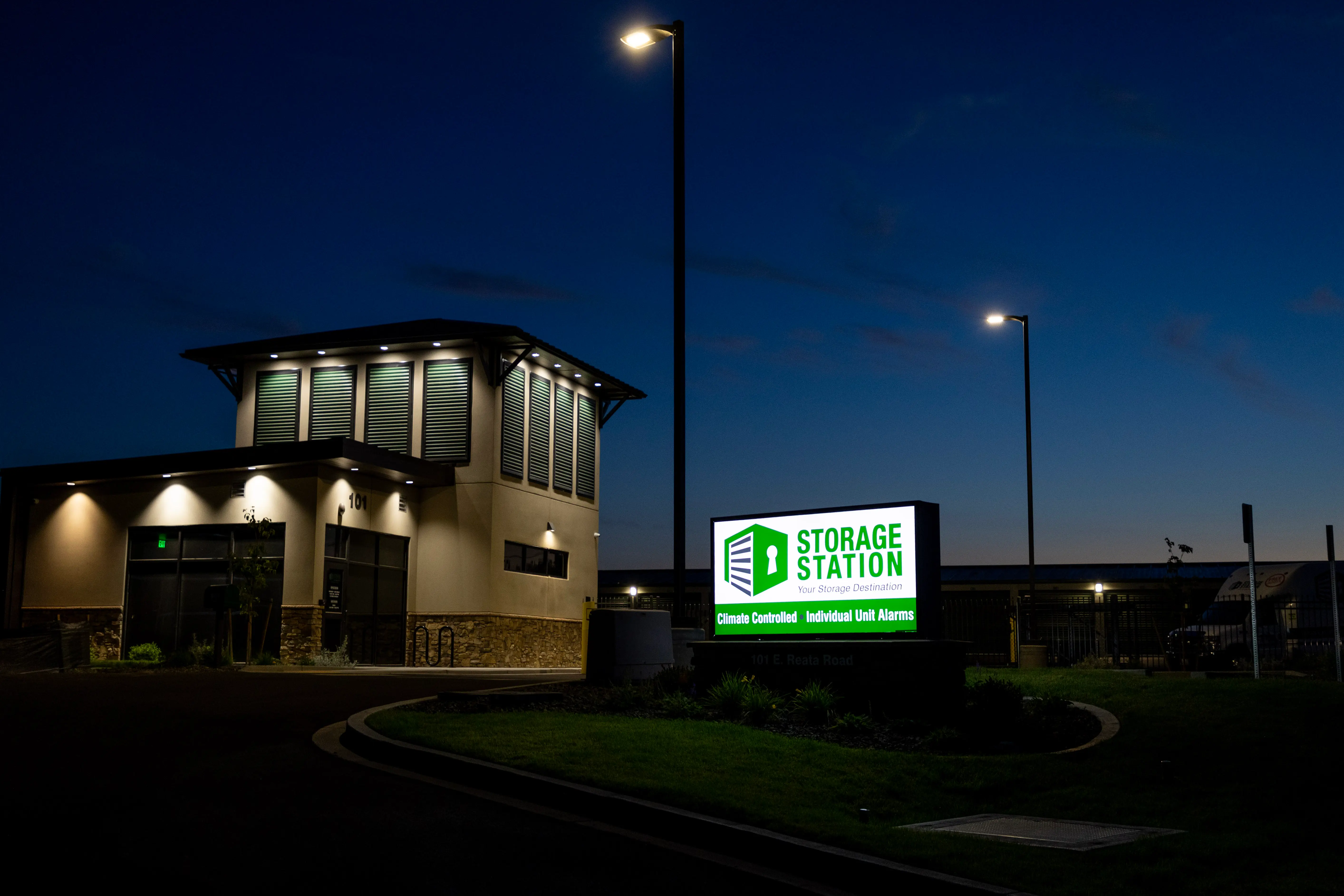 Storage Station office and illuminated monument sign at night
