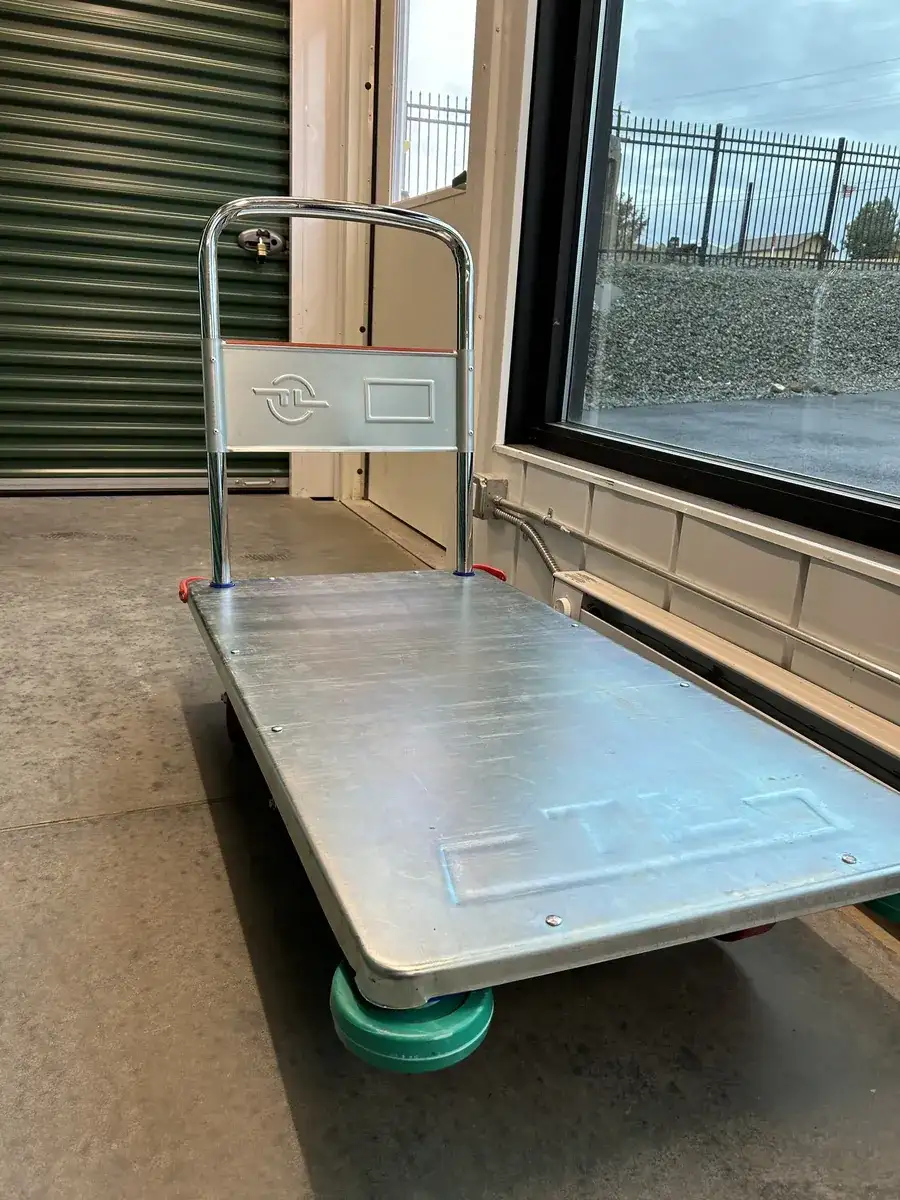 Free flatbed moving cart inside the climate-controlled building near the entry door