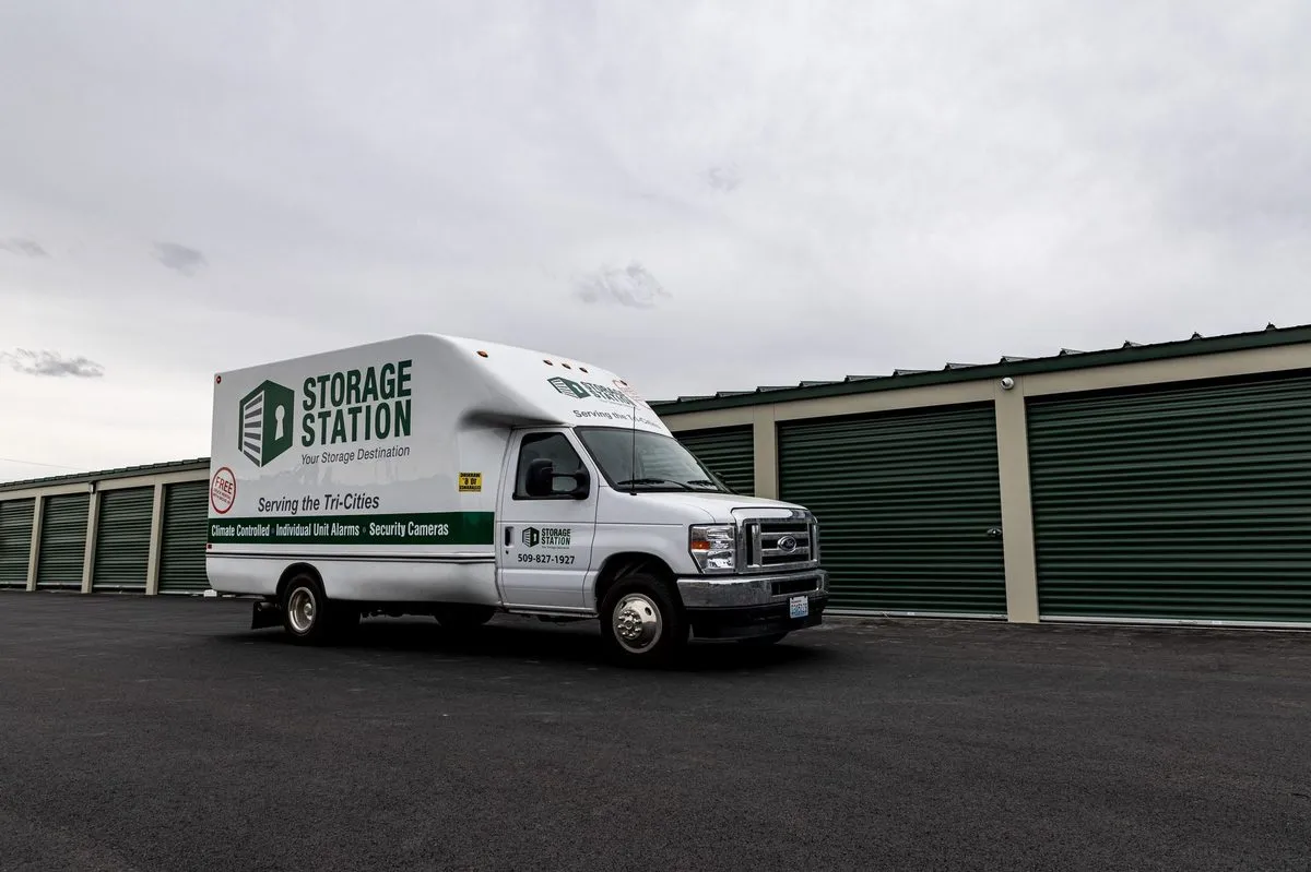 Storage Station moving truck parked beside storage units