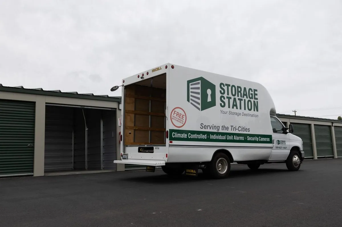 Storage Station moving truck with cargo door open, showing interior